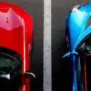 top view photo of red and blue convertibles on asphalt road