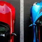 top view photo of red and blue convertibles on asphalt road
