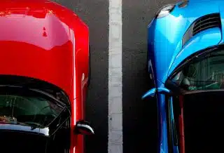 top view photo of red and blue convertibles on asphalt road