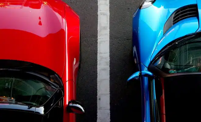 top view photo of red and blue convertibles on asphalt road