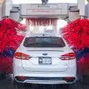 white Ford vehicle on car wash shop